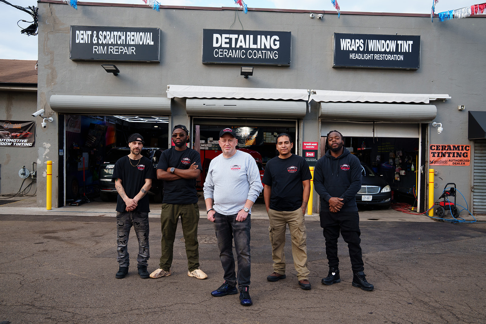 The Waxman crew in front of the Jersey City body shop bays