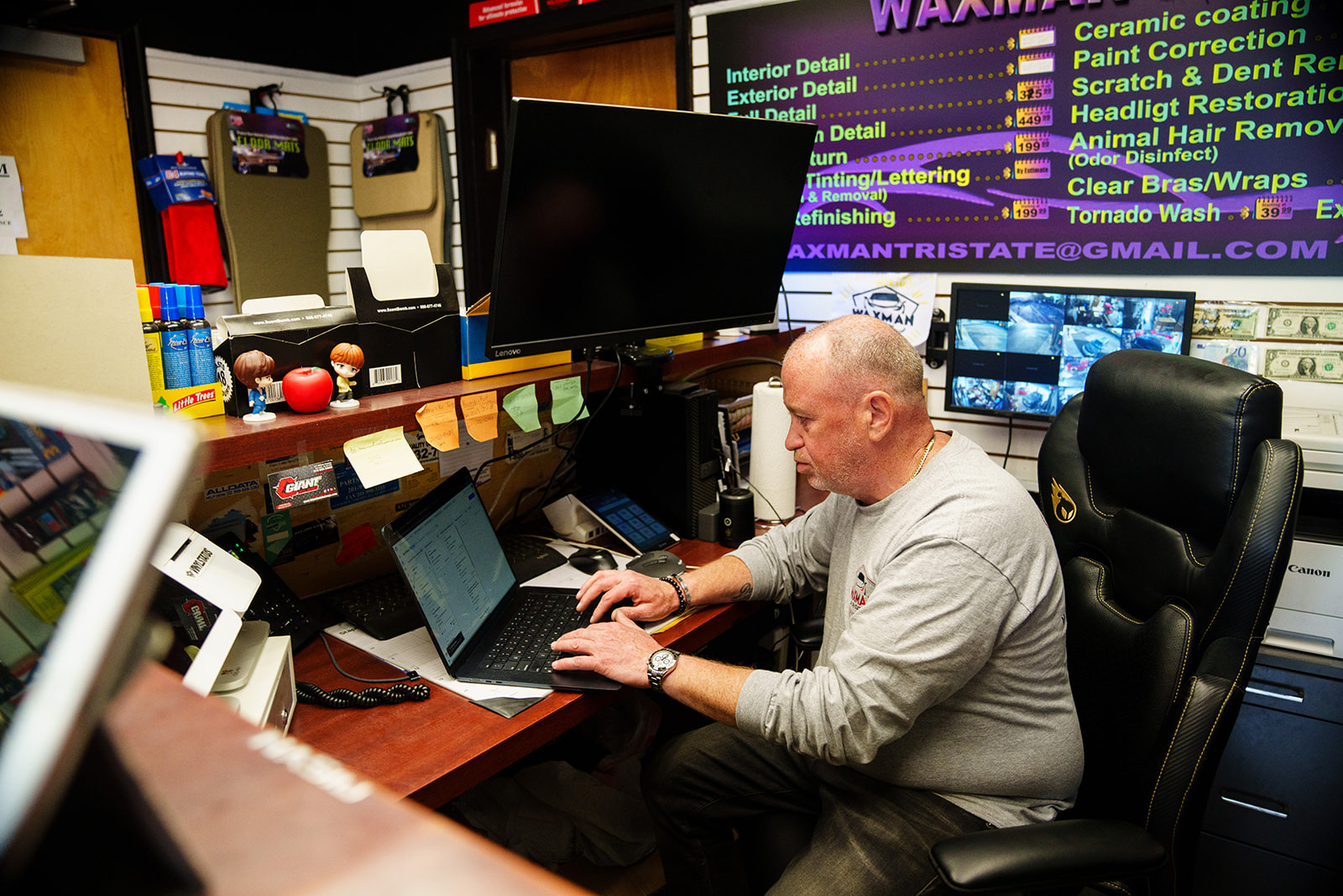 Waxman owner preparing a repair estimate at the front-desk computer in the Jersey City shop office