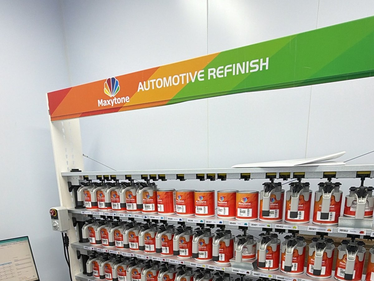 Maxytone Automotive Refinish toner bank with rows of labeled mixing tins in the paint mixing room at Waxman on Bayview Ave, Jersey City