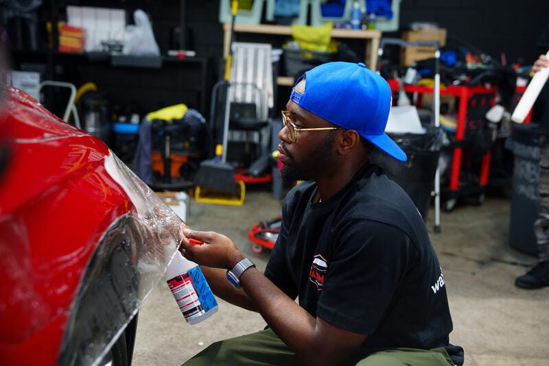 Paint protection film being fitted to a panel in the installation area