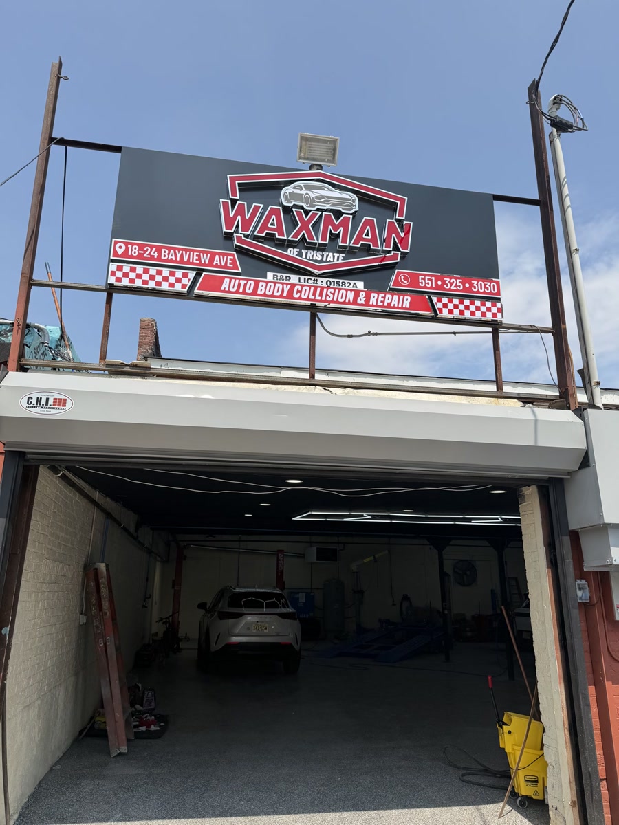 Waxman of Tristate Auto Body sign above the open repair bay at 18-24 Bayview Ave, Jersey City